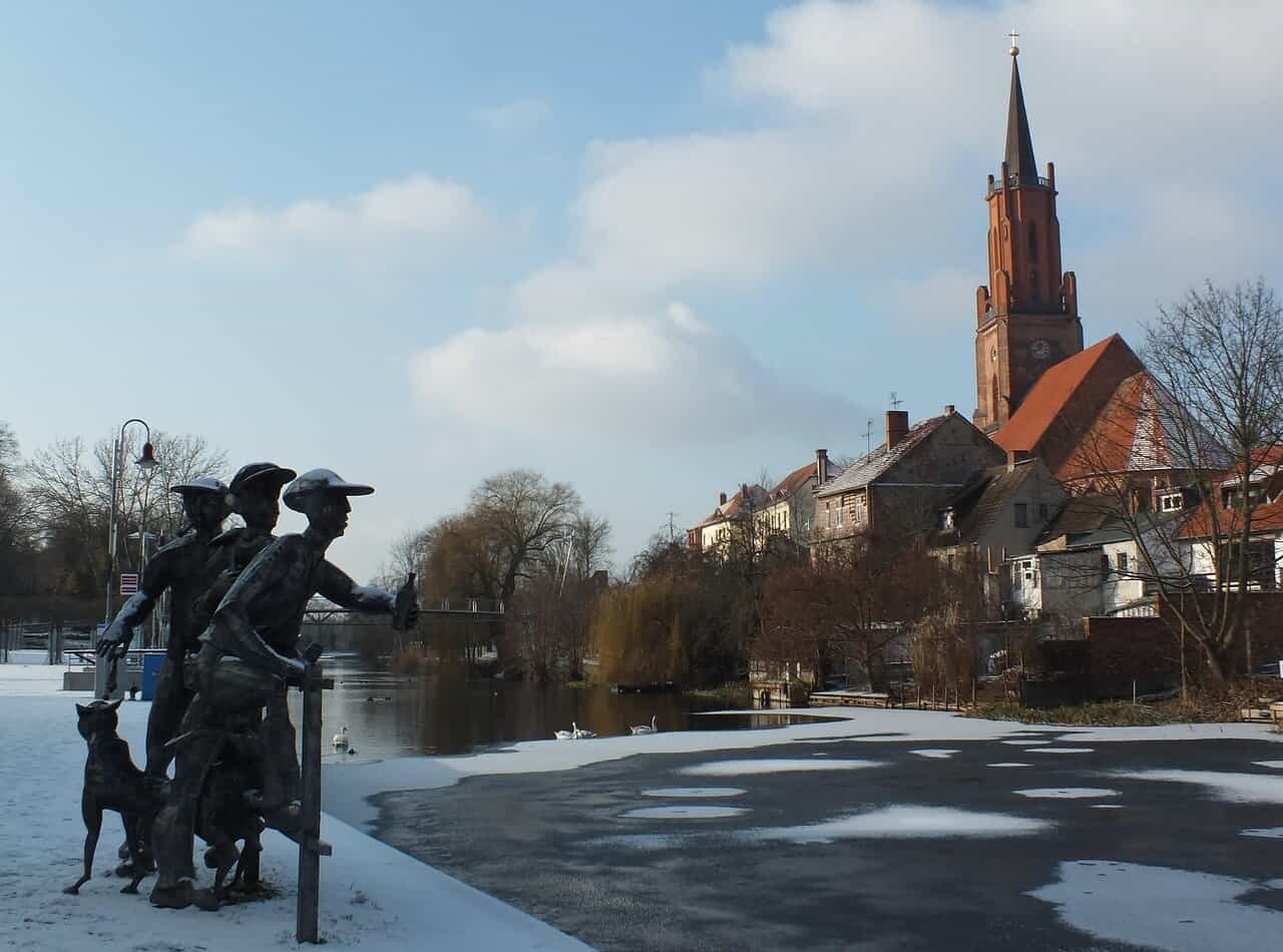 Schleusenspucker-Skulptur am Stadtkanal und St.-Marien-Andreas-Kirche in Rathenow